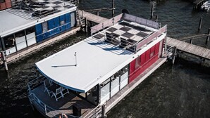 A riverboat with a flat deck and a covered area with a checkered floor. - Apartment in Mecklenburg Western Pomerania (Goehren-Lebbin)