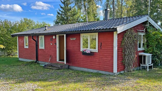 A red single-story house with a sloped roof, a front door, and a small porch area. - 6 Person Holiday Home in Vingaker (Vingåker)