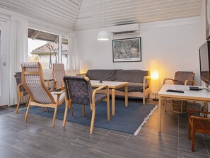 A cozy living area with a sofa, two chairs, a table, and a TV. - 6 Person Holiday Home on a Holiday Park in Karrebaeksminde (Karrebæksminde)