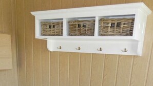 A white storage unit with wicker baskets on a blue tiled floor. - Holiday Home \"baltic Sea Dream\" (Garz/Rügen)
