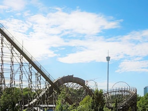 A roller coaster with a steep incline and a circular loop, surrounded by greenery and a clear sky. - 4 Star Holiday Home in Goteborg (Gothenburg)