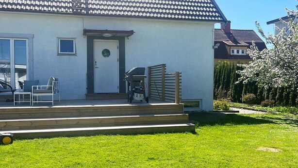 A house with a white exterior, a tiled roof, and a front porch with steps leading to a door. - 4 Star Holiday Home in Goteborg (Gothenburg)