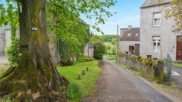 A narrow rural road flanked by stone houses with ivy-covered walls. - Charming Holiday Home in Clavier With Garden (Clavier)