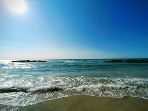 A beach with waves, clear sky, and a sun. - 4 Star Holiday Home in Hjorring (Hjørring)