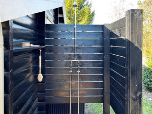 A wooden gate with a metal latch and a hanging object. - 7 Person Holiday Home in Hojby (Hojby)