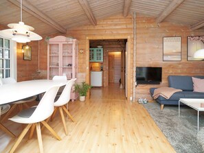 A wooden interior with a dining area, kitchen, and living space. - 7 Person Holiday Home in Hojby (Hojby)