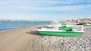 A sandy beach with several green and white boats lined up. - Residence With Swimming Pool Nearby the sea (Rimini)