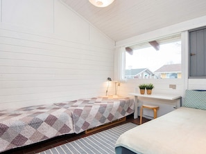 A small, single-bed room with a window, a desk, and a chair. - 4 Star Holiday Home in Aabenraa (Aabenraa)