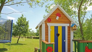A wooden playhouse with a striped door, a heart-shaped window, and a mushroom decoration on the roof. - Apartment in Sveti Petar u Sumi (Sveti Petar u Sumi)