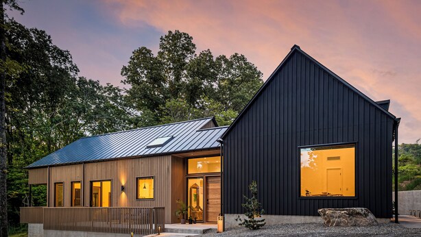 A modern house with a large garage, a wooden exterior, and a metal roof. - Architect-Designed 3BR Forest Retreat Near Asheville (Weaverville)
