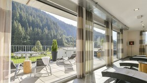 A modern hotel room with a balcony overlooking a mountainous landscape. - Flat in Arlberg Near Ski Slopes & Sauna (Klösterle am Arlberg)
