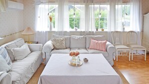 A living room with a sofa set, a coffee table, and a chair. - 5 Person Holiday Home in Skummeslovsstrand (Skummesloevsstrand)