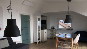A modern apartment with a dining area, kitchen, and living room. - Holiday Apartment Hammerle-seiler (Ueberlingen)