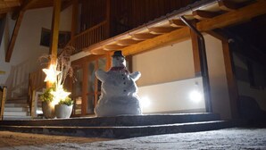A snowman statue outside a wooden building with a balcony. - Pleasant Holiday Home With View (Garmisch-Partenkirchen)