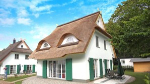 A traditional house with a thatched roof, white walls, and green shutters. - Droom Unter Reet 2 Comfortable Holiday Residence (Rerik)