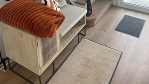 A staircase with black railings and beige steps, leading to a door with a frosted glass panel. - Renovated house near beaches and golf (Bénodet)
