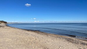 A beach with clear skies and calm water. - 5 Person Holiday Home in Brosarp (Brosarp)