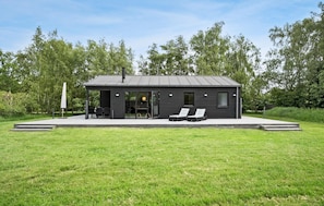 Relax in a serene setting with a welcoming entrance and outdoor seating area.