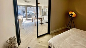 A hotel room with a large sliding glass door leading to an outdoor seating area. - Beautiful Holiday Home Near sea in Katwijk (Katwijk Aan Zee)