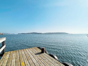 A wooden pier extending into calm waters with a clear sky above. - 4 Star Holiday Home in Fagerfjall (Fagerfjäll)