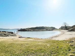 A coastal landscape with a rocky shoreline, a sandy beach, and a clear sky. - 4 Star Holiday Home in Fagerfjall (Fagerfjäll)