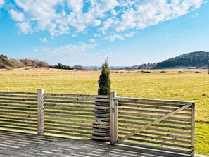 A wooden fence with a gate, a grassy field, and a clear sky. - 4 Star Holiday Home in Fagerfjall (Fagerfjäll)