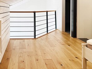 A room with a wooden floor, a white wall, and a black metal railing. - 4 Star Holiday Home in Fagerfjall (Fagerfjäll)