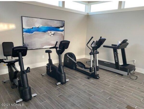A home gym with a stationary bike, elliptical, and treadmill. - Resort style, beach town cottage, 5 mins from the beach- family friendly. (Beaufort)