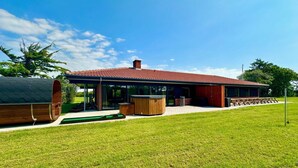 A modern house with a red roof, large windows, and a covered patio area. - 4 Star Holiday Home in Ulfborg (Ulfborg)