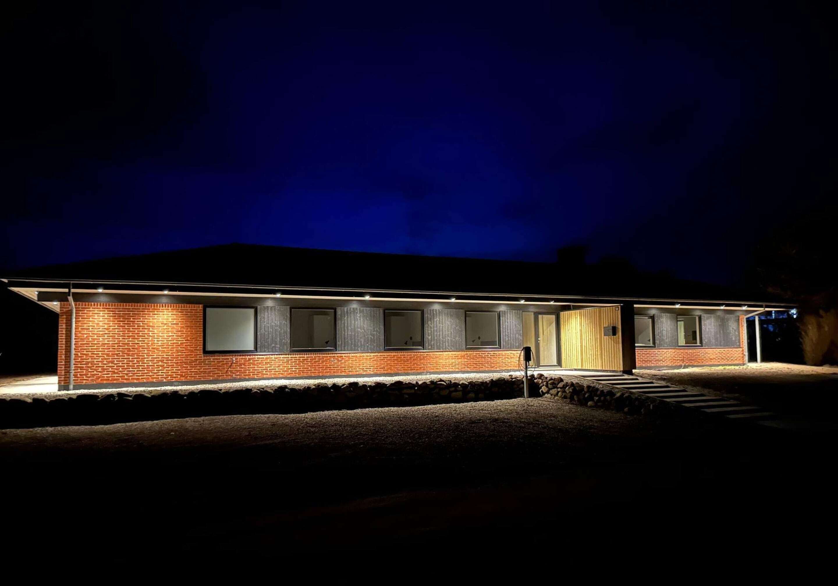 A single-story building with a brick facade, a flat roof, and a front entrance with a door.
