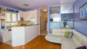 A modern apartment with a kitchen, a living area with a sofa, and a dining area. - Apartment 3 Beaches With Free Parking (Dubrovnik)