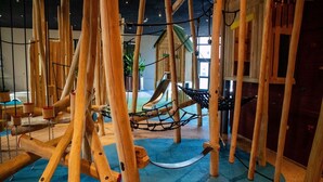 A wooden play structure with a rope bridge and a slide. - Luxurious Holiday Home With Sauna in Limburg (Roggel)