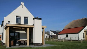 A modern house with a white exterior, a red roof, and a large satellite dish. - Luxurious Holiday Home With Sauna in Limburg (Roggel)