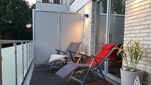 A deck with two lounge chairs, a potted plant, a candle, and a star decoration. - High Geest 4 - Including Many Extras (Cuxhaven)