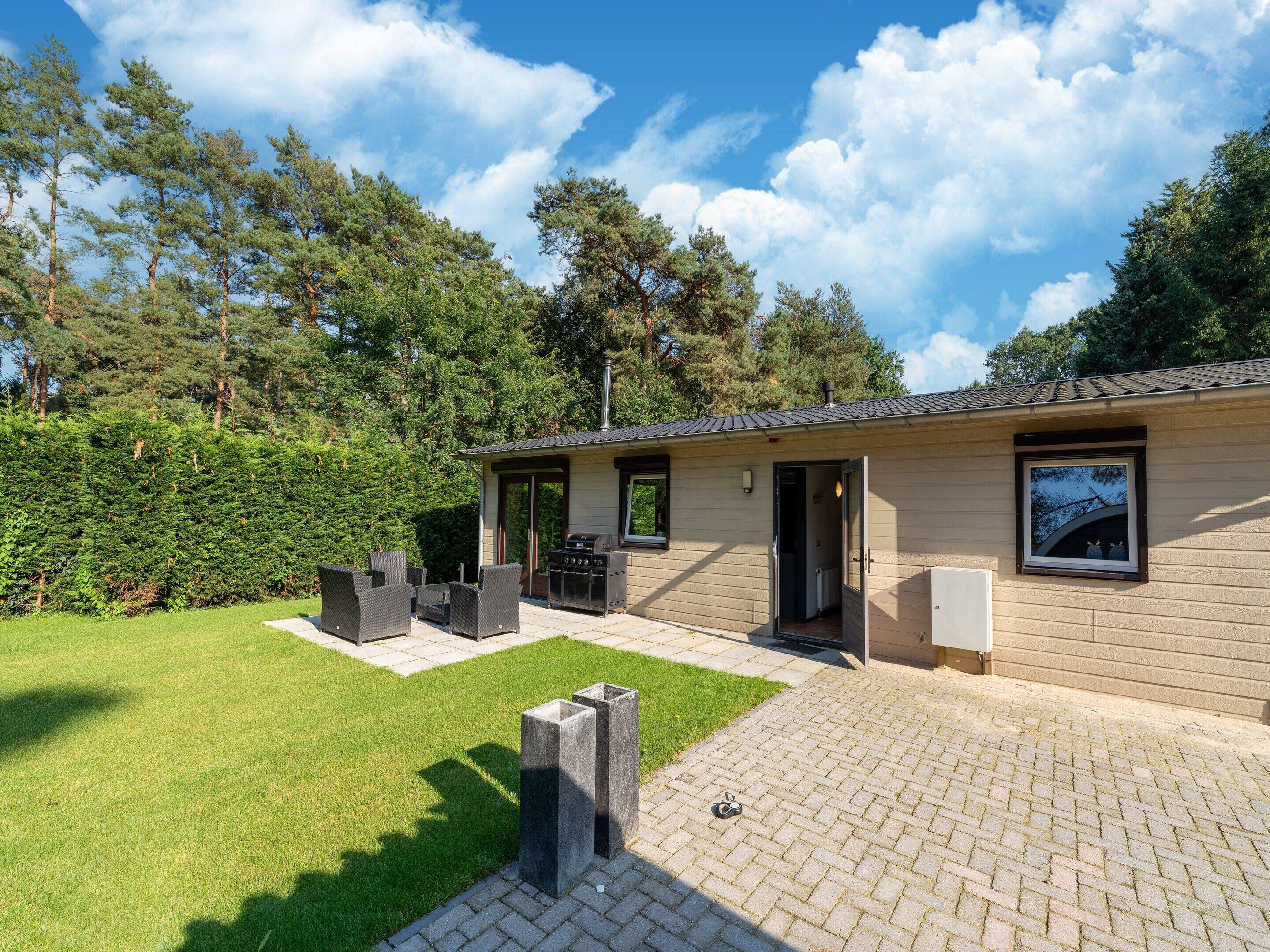 A house with a patio, outdoor seating, and a barbecue area.