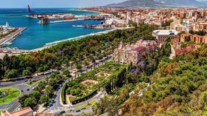 A coastal cityscape with a marina, dense urban buildings, and a park area. - Belvilla by OYO Casa El Pinar (Torremolinos)