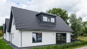 A modern single-story house with a sloped roof, large windows, and a small attached garage. - Beautiful Holiday Home Near Alkmaar (Hensbroek)