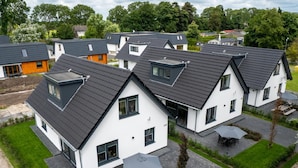 A modern residential complex with multiple houses featuring pitched roofs and large windows. - Beautiful Holiday Home Near Alkmaar (Hensbroek)