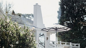 A white staircase leading to a covered porch with a white railing.