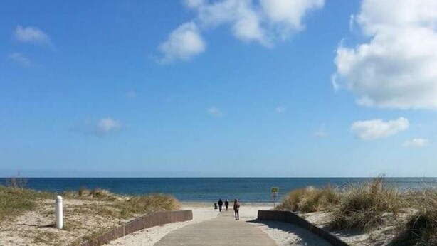A beach pathway leading to the sea with a clear sky and a few clouds. - Beach Dune 18 on the Beach (Karlshagen)