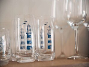 A row of clear glasses with a lighthouse design. - Nice Apartment on Ameland With Balcony/terrace (Buren)