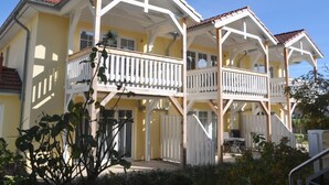 A two-story building with a balcony on the upper floor. - Beach Dune 12 on the Beach (Karlshagen)