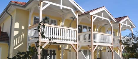 A two-story building with a balcony on the upper floor.