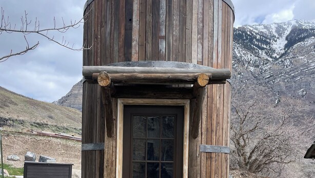 A rustic wooden cabin with a brown door, stone steps, and a mountainous backdrop. - Best Mountain View in Utah. Rustic ranch setting.  (Provo)