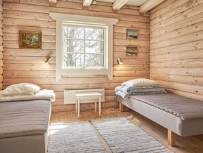 A cabin-style room with two single beds, a window, and a radiator. - 6 Person Holiday Home in Ronne (Ronne)