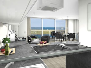 A modern kitchen with a large island, dining area, and a view of the sea. - Holiday Home in Wendtorf (Wendtorf)