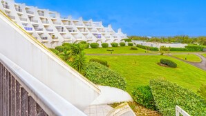 A modern hotel with a unique zigzag architectural design, featuring balconies and a well-maintained lawn. - Le Parador by Interhome (La Grande Motte)