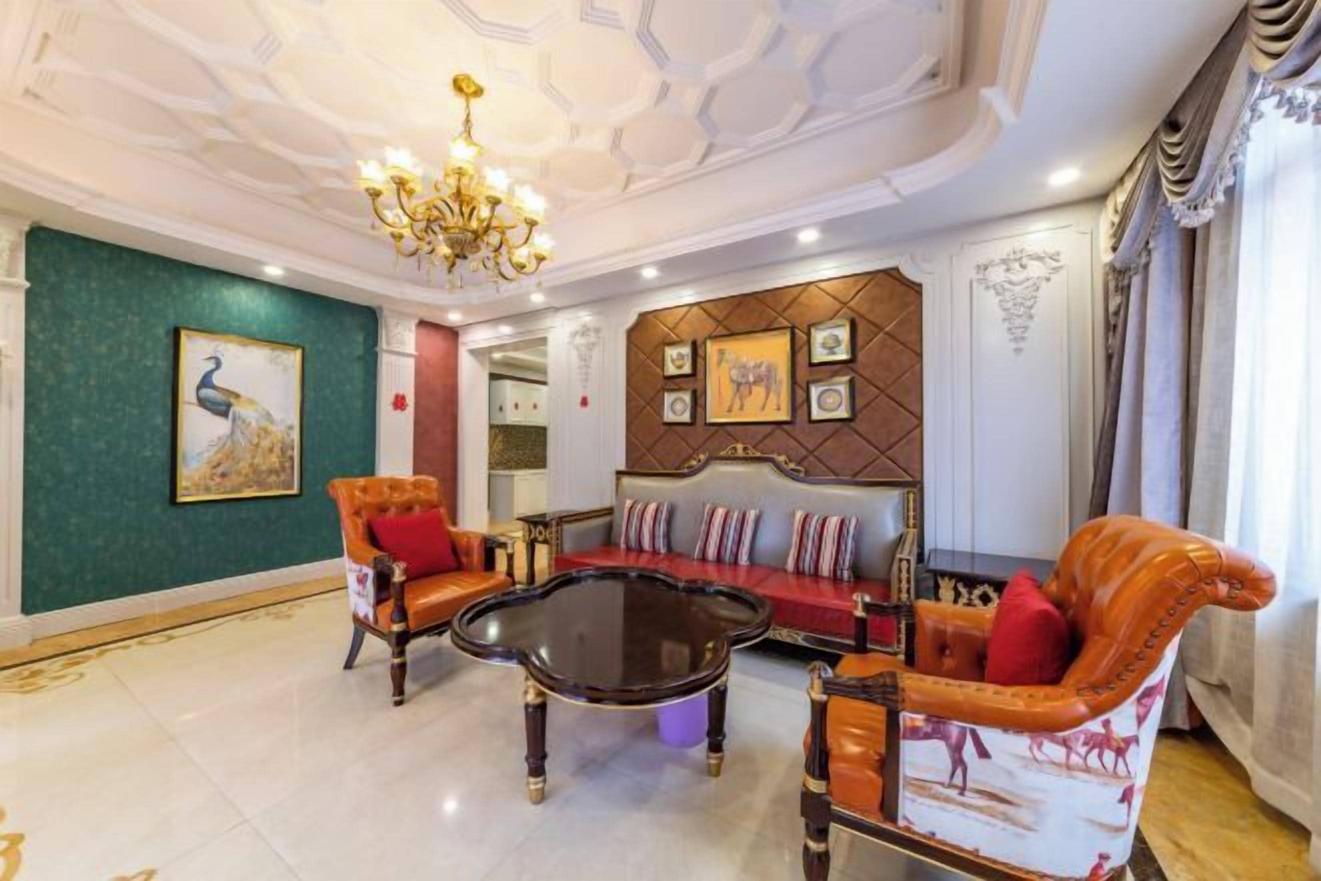 A spacious living room with a sofa set, a coffee table, and a chandelier.