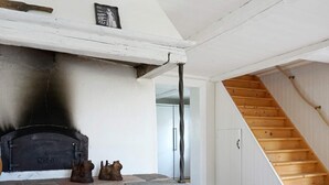 A rustic interior with a stone fireplace, a wooden staircase, and a simple, clean design. - 6 Person Holiday Home in Hedekas-by Traum (Hedekas)