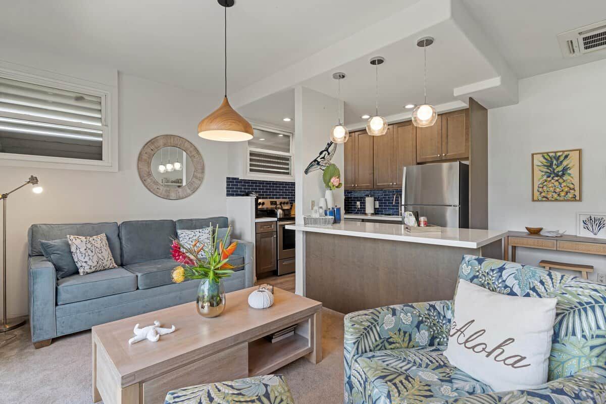 A modern living room with a sofa, coffee table, and decorative items.